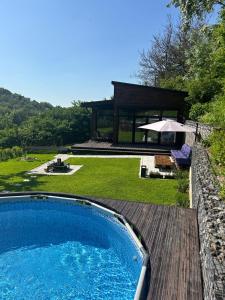 a swimming pool in a yard with a house at Country House in Almaty