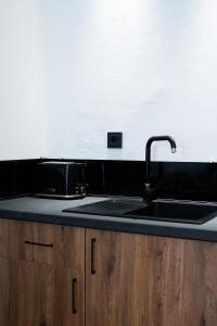 a kitchen with a sink and a counter top at Host2U Highland Hideaway Bansko in Bansko