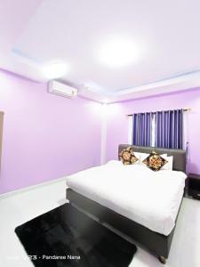 a bedroom with a bed with purple walls at AWA Pool Villa in Ban Huai Yai +33 photos