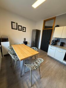 a kitchen with a table and chairs in a room at soulfactory budget in Neu-Ulm +18 photos