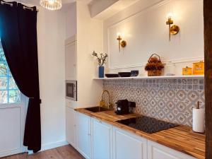 Η κουζίνα ή μικρή κουζίνα στο L'Appartement +5 φωτογραφίες