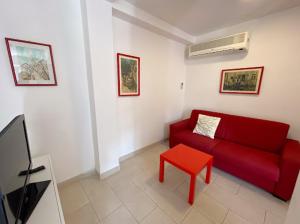 a living room with a red couch and a red stool at Casalago in Bolsena