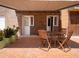 a patio with a table and chairs on a patio at Casalago in Bolsena