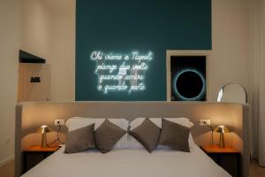 a bedroom with a bed with a sign on the wall at Toledo LR Collection in Naples