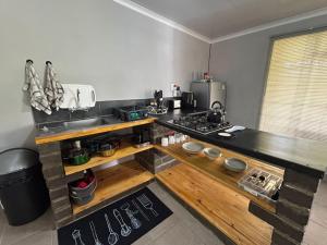 a kitchen with a stove and a counter top at Kufihliwe Lodge in Ingogo