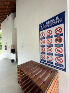 a sign on the wall of a building with a wooden bench at Chã Grande - Cantinho Premium in Chã Grande