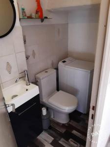 a small bathroom with a toilet and a sink at Duplex Eden Park in Le Pradet +10 photos