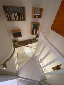 a white staircase in a room with a table at Duplex Eden Park in Le Pradet