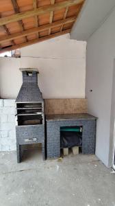 a kitchen with a stove in a room at Descanso - Casa de Praia in Mongaguá