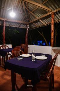 a table with a blue table cloth on top of it at Maka Safari Village Resort in Udawalawe