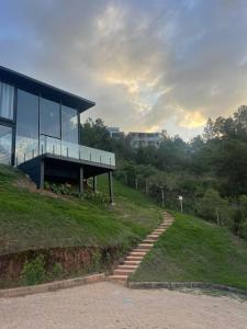 a building on top of a hill with some stairs at Casa Vilas Boas Macacos in Nova Lima