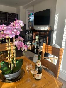 a table with two glasses of wine and flowers on it at The Magnolia in Rhos-on-Sea +15 photos