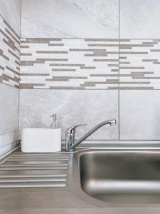 a bathroom with a sink and a sink at Mountain View Apartment in Sibiu +9 photos