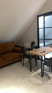 a living room with a couch and a table at Apartament Przytulny 7- Harmonia, self check in, parking in Rzeszów +11 photos