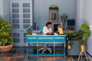 a woman sitting at a desk in an office at Nour Boutique Hotel in Dahab