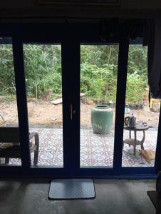 a view of a patio through a glass door at Villa Somkid in Ban Hua Laem