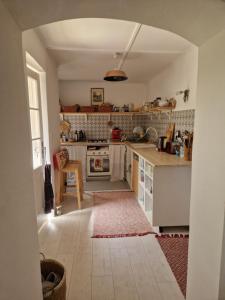 a kitchen with white cabinets and a counter top at Porta in Bálványos