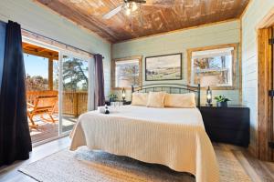 a bedroom with a bed and a balcony at Luxe Mountain Pool Escape by Ghosal Luxury Lodging in Gatlinburg +65 photos
