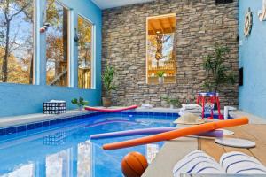 a swimming pool with basketballs in a house at Luxe Mountain Pool Escape by Ghosal Luxury Lodging in Gatlinburg