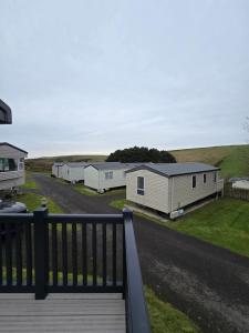 a row of mobile homes on the side of a road at Durdle Door family Holiday Home in West Lulworth +18 photos
