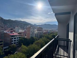a view of a city from the balcony of a building at Mantu Apartment in Cusco