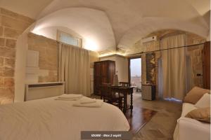 Postel nebo postele na pokoji v ubytování Chiesa Greca Suites - Lecce Selection
