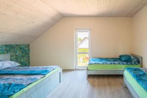 a room with two beds and a window at Morski domek in Dębki