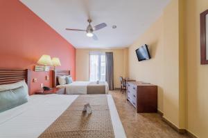 a hotel room with a bed and a tv at Seven Crown La Paz Centro Historico in La Paz +64 photos