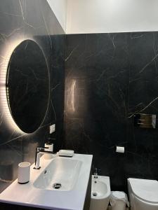 a bathroom with a sink and a mirror and a toilet at Sweet dreams in Palermo +48 photos