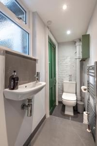 a bathroom with a sink and a toilet at Chic 1-bed Garden Flat, London, Convenient for Tower Bridge, Great Public Transport in London
