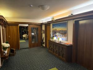 a hallway of a hotel room with a painting on the wall at Hotel Garni Schick in Oberursel