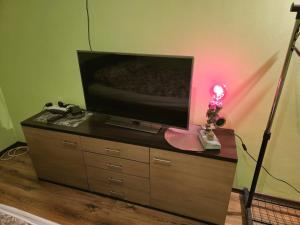 a television on top of a dresser with a lamp at Guesthouse Sauna Jacuzzi Free parking in Dobrzewino