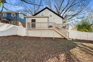 a house with a white fence in front of it at Atlanta Modern Escape Prime Location & Spacious Living sleeps 14 in Atlanta