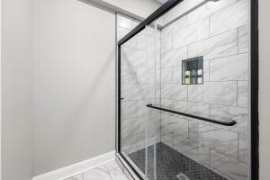 a shower with a glass door in a bathroom at Atlanta Modern Escape Prime Location & Spacious Living sleeps 14 in Atlanta +15 photos