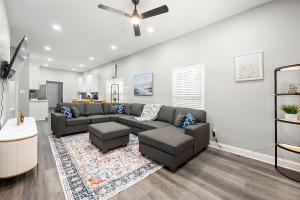 a living room with a couch and a ceiling fan at Atlanta Modern Escape Prime Location & Spacious Living sleeps 14 in Atlanta