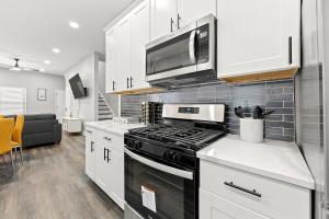 a kitchen with a stove and a microwave at Atlanta Modern Escape Prime Location & Spacious Living sleeps 14 in Atlanta
