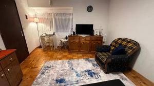 a living room with a couch and a television at Casa Amarela - Aldeias - Serra da Estrela in Gouveia