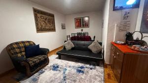 a living room with a couch and a chair at Casa Amarela - Aldeias - Serra da Estrela in Gouveia