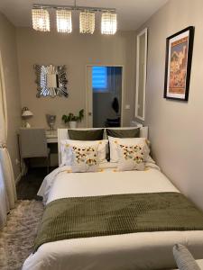 a bedroom with a large bed and a desk at A La Fleur d Oranger - Lille La Madeleine in La Madeleine