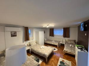 a living room with three beds and a couch at Lucky Apartments in Leskovac