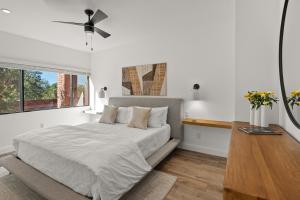a white bedroom with a bed and a window at Quartz Villa in Sedona
