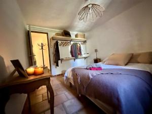 a bedroom with a bed and a mirror and a lamp at Rez de jardin au calme dans le parc des calanques in La Ciotat +45 photos