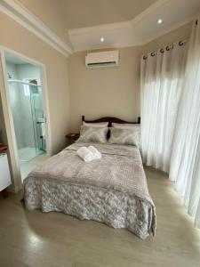 a bedroom with a bed with two towels on it at Suíte Santa Catarina in Pomerode