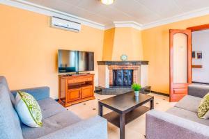 a living room with two couches and a fireplace at Villa Joel - Casa con piscina cerca de la playa in Son Carrio