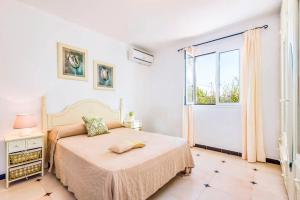 a bedroom with a bed and a large window at Villa Joel - Casa con piscina cerca de la playa in Son Carrio +15 photos