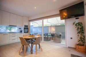 a kitchen and dining room with a table and chairs at Kalafatis Garden House in Itea