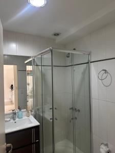 a bathroom with a shower and a sink at Boulogne Design Suites in Mendoza