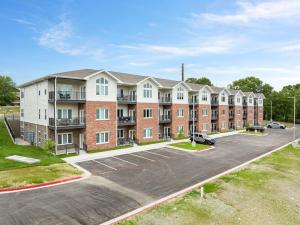 an apartment building with a parking lot at Spacious Retreat, Heart of the City, Indoor Pool, Free Attraction Tickets! in Branson