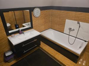 a bathroom with a tub and a sink and a shower at Guesthouse Sauna Jacuzzi Free parking in Dobrzewino +9 photos