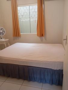 Ένα ή περισσότερα κρεβάτια σε δωμάτιο στο Casa praia matinhos
